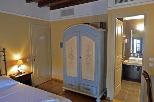 a bedroom with a bed and a dresser in a room at Archontiko Leontari in Leondari