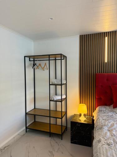a bedroom with a black shelf next to a bed at Guest house in Lyckeby in Karlskrona