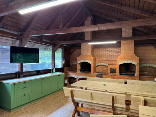 a large room with a brick ovenasteryasteryasteryasteryasteryasteryasteryasteryastery at Casutele Ariesene in Arieşeni