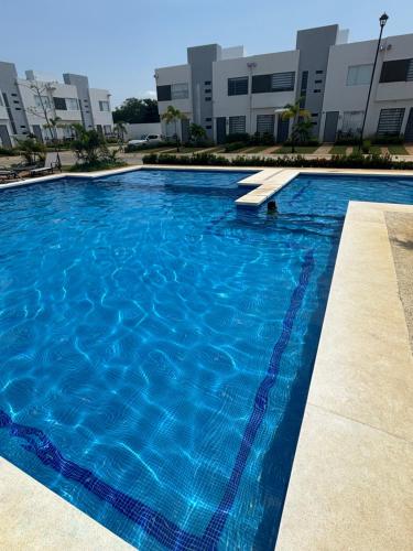 a large swimming pool in front of a building at Acapulco Diamante in Cedro