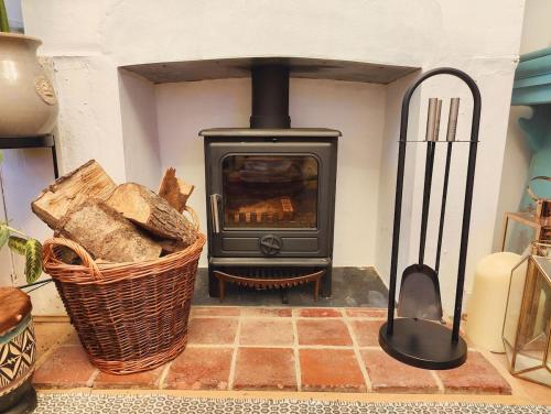 a stove in a room with a basket of bread at Writers Retreat in the heart of Ashford Town in Kent