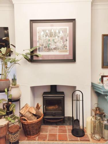 a living room with a fireplace with a picture on the wall at Writers Retreat in the heart of Ashford Town in Kent