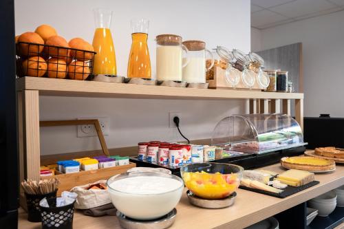 a counter with some food and drinks on it at Nemea Appart Hotel Les Hauts de Milady Biarritz in Biarritz