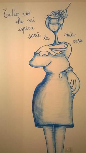a drawing of a woman with a clock on her head at Pedrales Orgosolo in Orgosolo