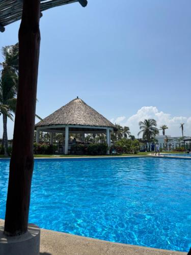 a swimming pool at a resort with a gazebo at Acapulco Diamante in Cedro
