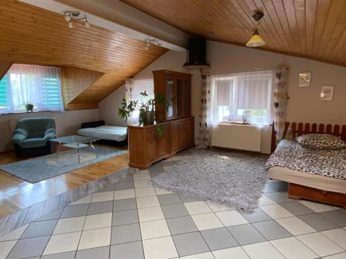 a large room with two beds and a table in it at Damentka's Nest in Warsaw