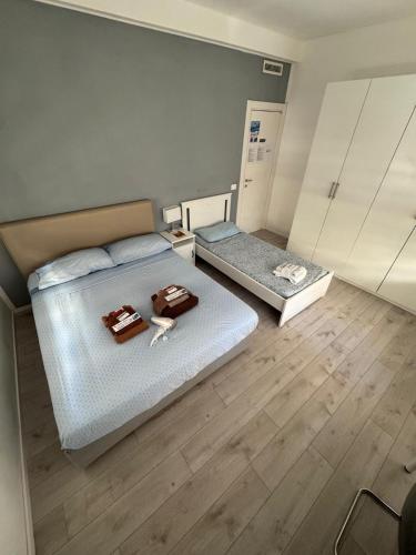 two beds in a room with wooden floors at Homes in Ancona CCA23 Rooms in Ancona