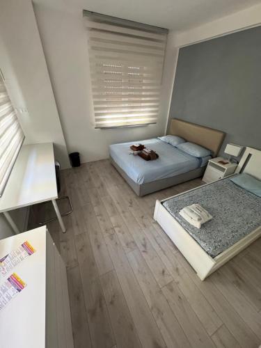 a small bedroom with two beds and a window at Homes in Ancona CCA23 Rooms in Ancona