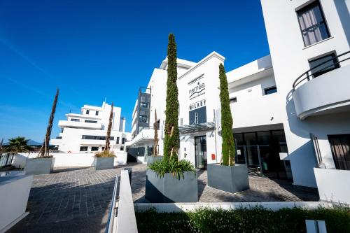 a row of trees in front of buildings at Nemea Appart Hotel Les Hauts de Milady Biarritz in Biarritz