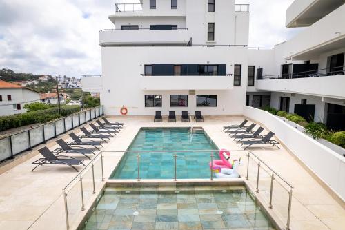 a swimming pool on the balcony of a building at Nemea Appart Hotel Les Hauts de Milady Biarritz in Biarritz