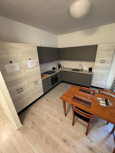a kitchen with a wooden table and a wooden floor at Homes in Ancona CCA23 Rooms in Ancona