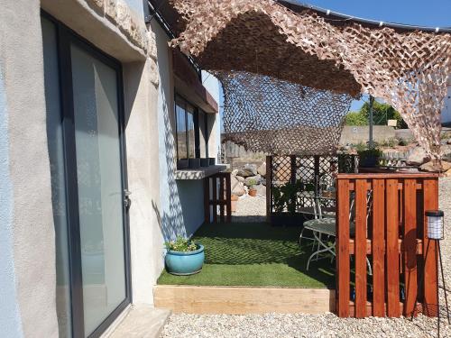 an open door of a house with a patio at Insinuances in Douzens