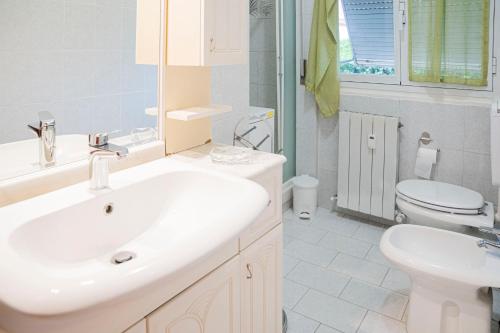 a white bathroom with a sink and a toilet at 039C- Casa Residenziale a Lavagna a 5 minuti dal mare in Lavagna