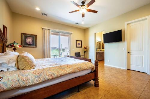 a bedroom with a bed and a ceiling fan at Spacious 3BR Retreat - Mtn Views & BBQ in Apache Junction