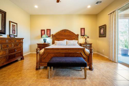 a bedroom with a wooden bed and a dresser at Spacious 3BR Retreat - Mtn Views & BBQ in Apache Junction