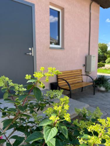 a wooden bench sitting on a patio next to a building at Apartment Vainagu street Sigulda in Sigulda