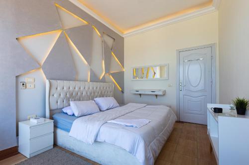 a bedroom with a large bed with yellow triangles on the wall at Hayah Suites & Rooms in Alexandria