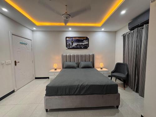 a bedroom with a bed and a desk and chair at ALAF Lodges in Dargai