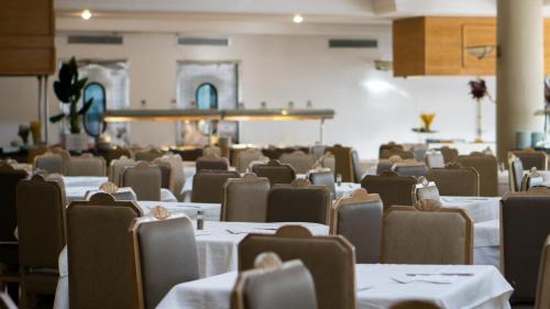 an empty dining room with tables and chairs at Golf Residence- Families and Couples Only in Hammam Sousse