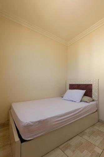 a bed in a room with a white bedvisor at Hayah Suites & Rooms in Alexandria