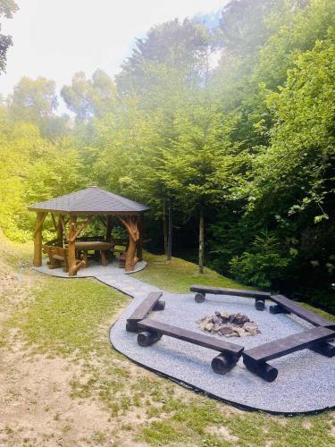a picnic table and a gazebo in a park at GABRA CHATA in Baligród