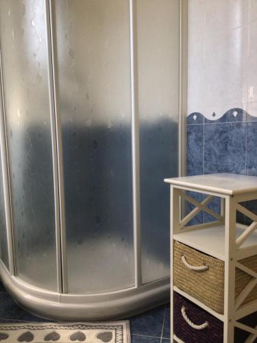 a shower stall in a bathroom with a table at Casale el galet in Moniga