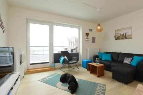 a dog laying on a rug in a living room at Marina Loft in Kappeln