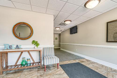 a waiting room with a chair and a mirror at Steps to Smith Mountain Lake Unit with Pool Access! in Huddleston