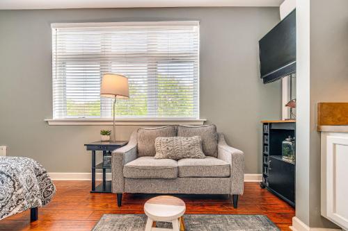 a living room with a couch and a window at Steps to Smith Mountain Lake Unit with Pool Access! in Huddleston