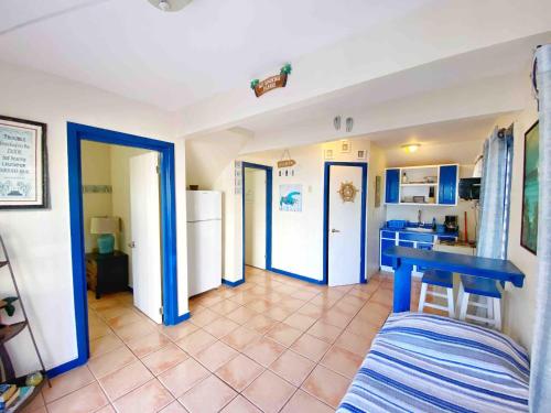 a kitchen with a blue table in a room at Spacious Two-Bedroom Getaway with Balcony by the Beach in Rincon