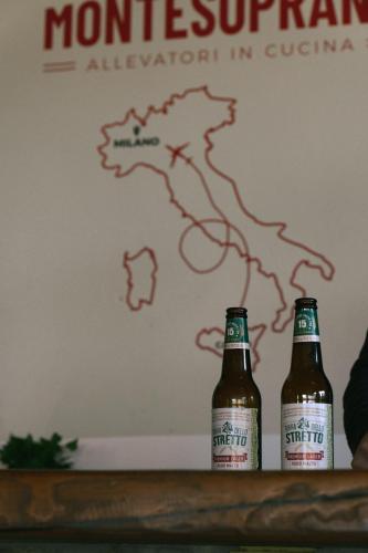two bottles of beer sitting on top of a table at MonteSoprano Agriturismo - Resort - Spa - Gym -Camping - Suite in Capizzi