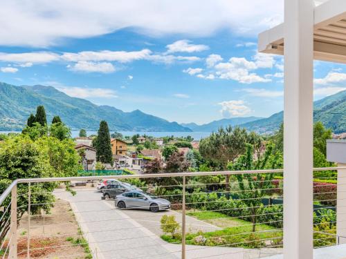 a view from the balcony of a villa with cars parked at Apartment Persico by Interhome in Consiglio di Rumo