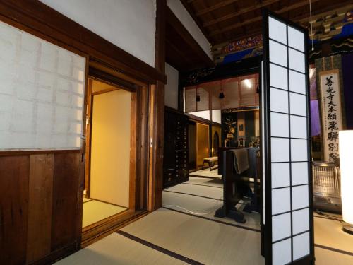 an entrance to a room with glass doors at Temple Hotel Takayama Zenkoji in Takayama