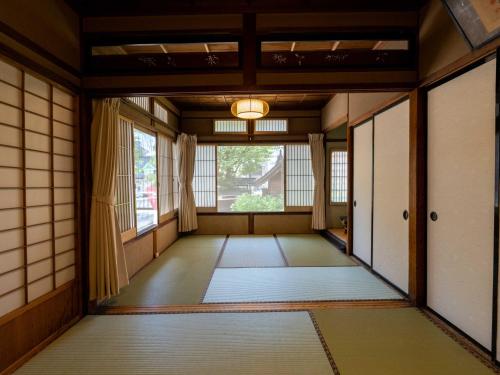 a japanese room with a door and a window at Temple Hotel Takayama Zenkoji in Takayama