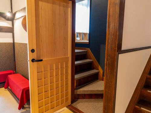 a door leading into a room with stairs at Temple Hotel Takayama Zenkoji in Takayama