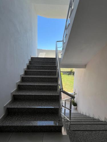 a staircase in a building with a stair case at 3rd Floor Mali i Robit Apartments in Golem
