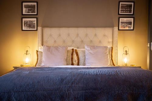 a bedroom with a large bed with two lamps at The Boat House Luxury Apartments Scarborough in Scarborough