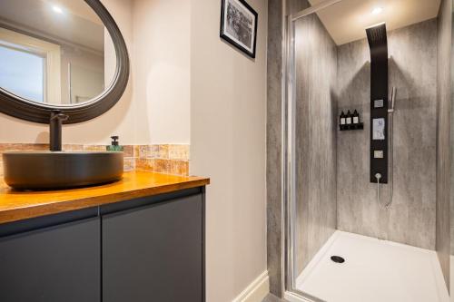 a bathroom with a sink and a mirror at The Boat House Luxury Apartments Scarborough in Scarborough