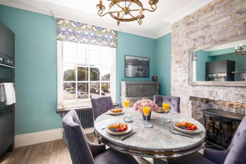 a dining room with a table and a fireplace at The Boat House Luxury Apartments Scarborough in Scarborough