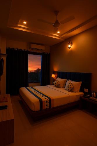 a bedroom with a large bed and a window at The Sky Comfort Hotel Brahm Sambandh in Nāthdwāra