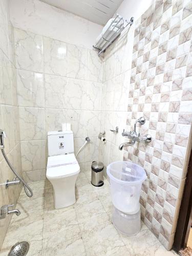 a bathroom with a toilet and a sink at The Sky Comfort Hotel Brahm Sambandh in Nāthdwāra