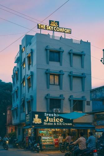 a blue building with a sign on top of it at The Sky Comfort Hotel Brahm Sambandh in Nāthdwāra