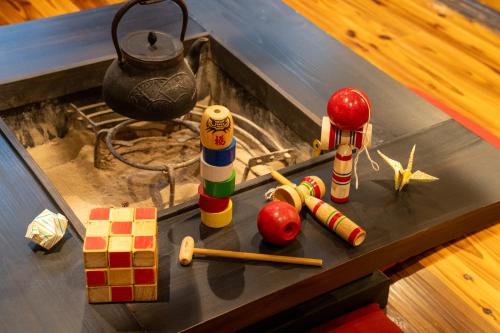 a table with toy figurines on top of it at Temple Hotel Takayama Zenkoji in Takayama