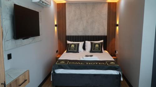 a hotel room with a bed with a flat screen tv at Dual Hotel Spa in Istanbul