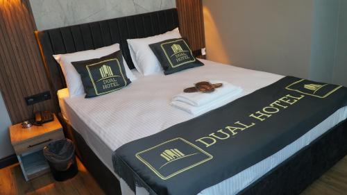 a large bed with a black and white bedspread at Dual Hotel Spa in Istanbul