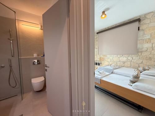 a bedroom with a bed and a bathroom with a shower at Zennova #65 Villa Vanina in Nikiti
