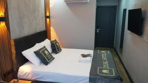 a small bed with two pillows on top of it at Dual Hotel Spa in Istanbul