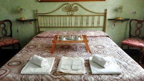 a bedroom with a bed with a table on it at Affittacamere Rilke in Trieste
