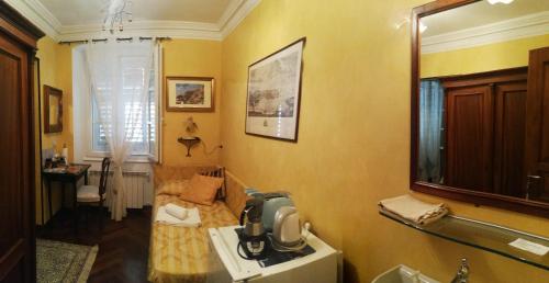 a bathroom with a sink and a mirror on the wall at Affittacamere Rilke in Trieste