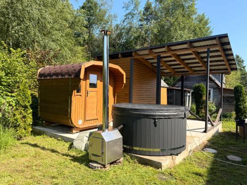 a small house with a trash can next to it at Igor House in Jūrmala